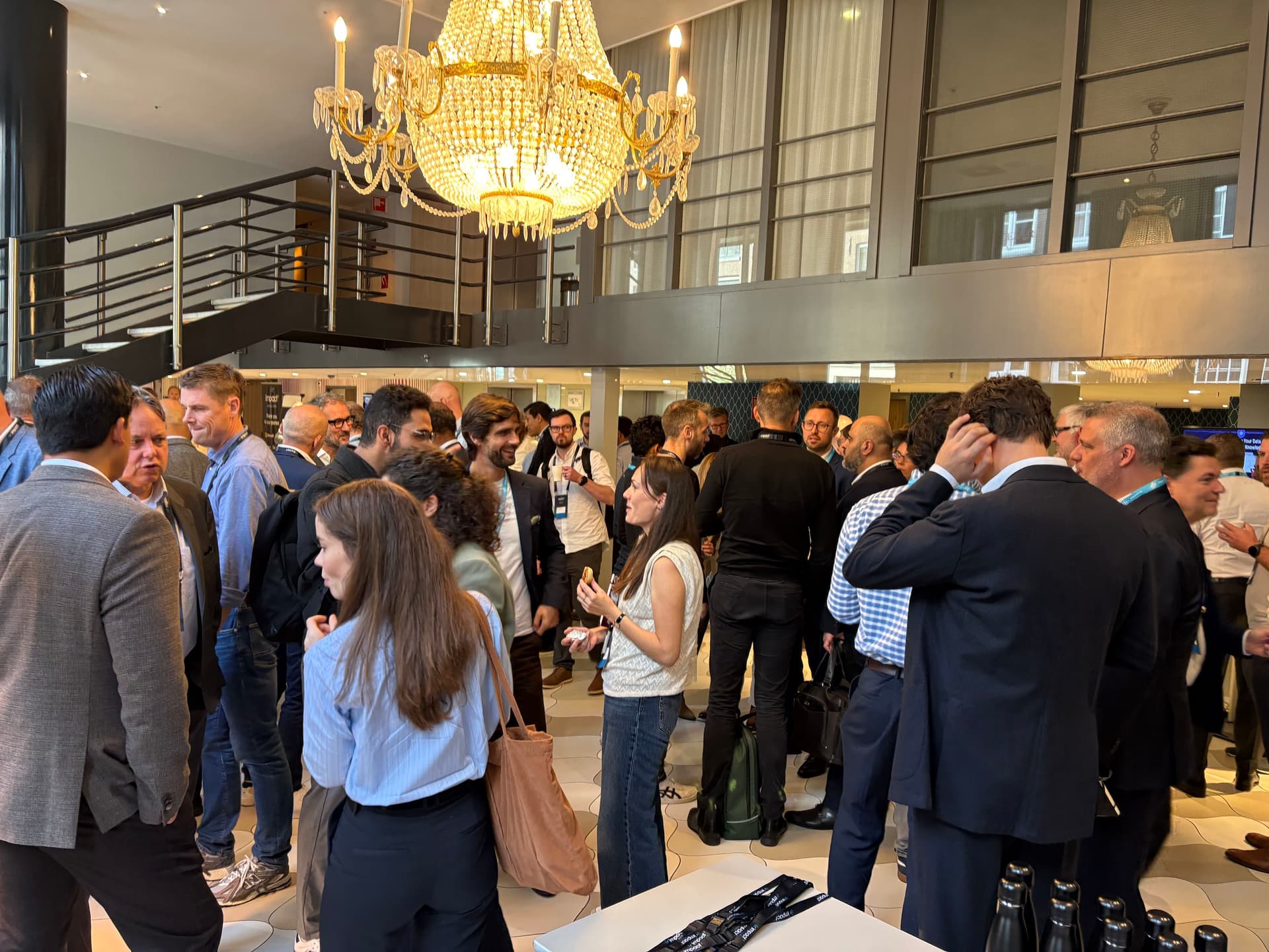 An image of attendees networking in the lobby